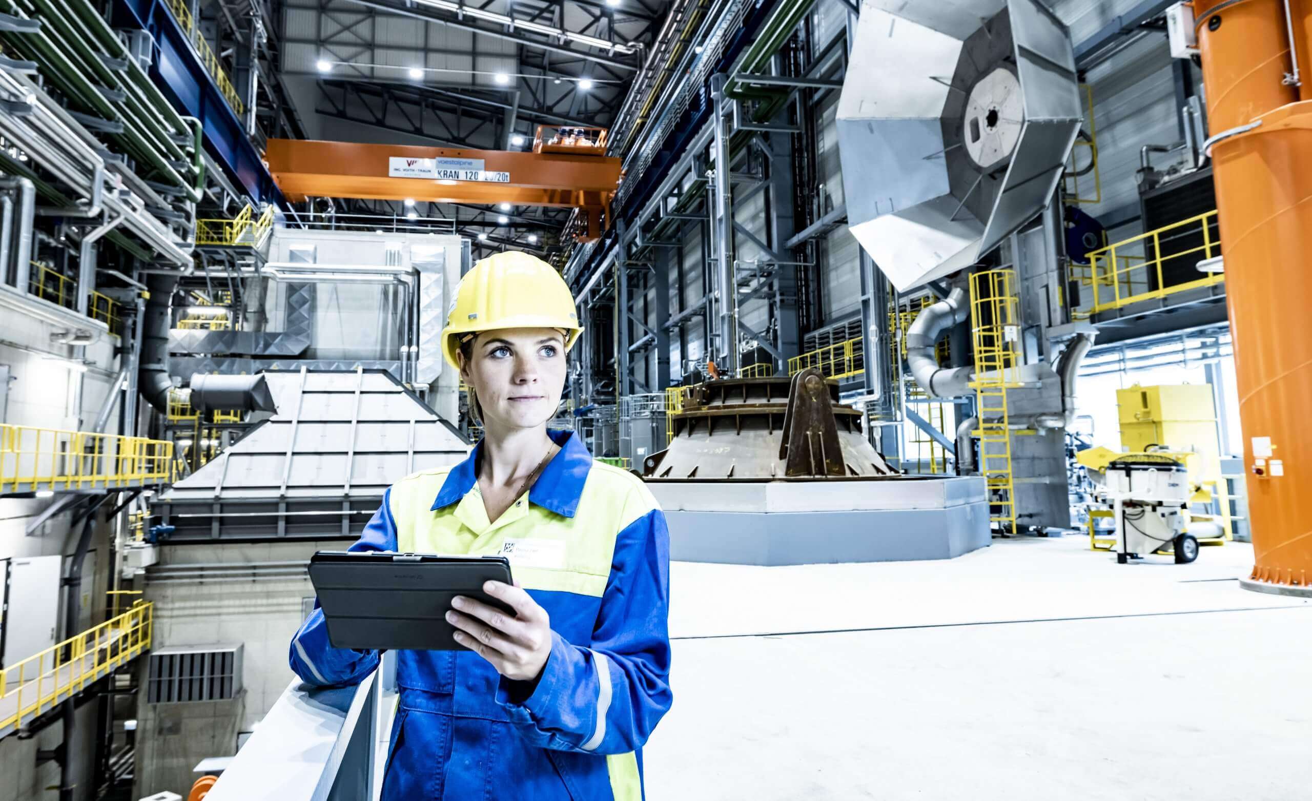 steel plant worker in safety gear inside a facility
