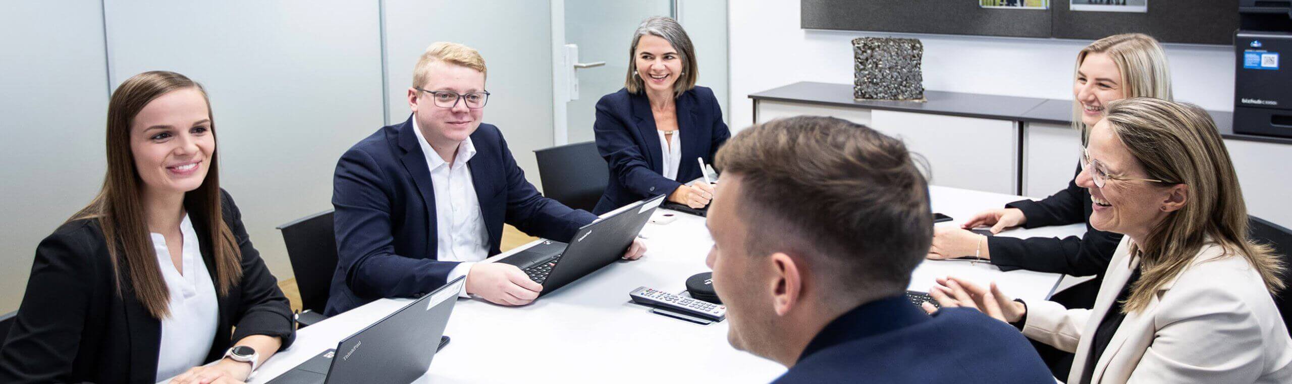 Colleagues in business attire at an office meeting
